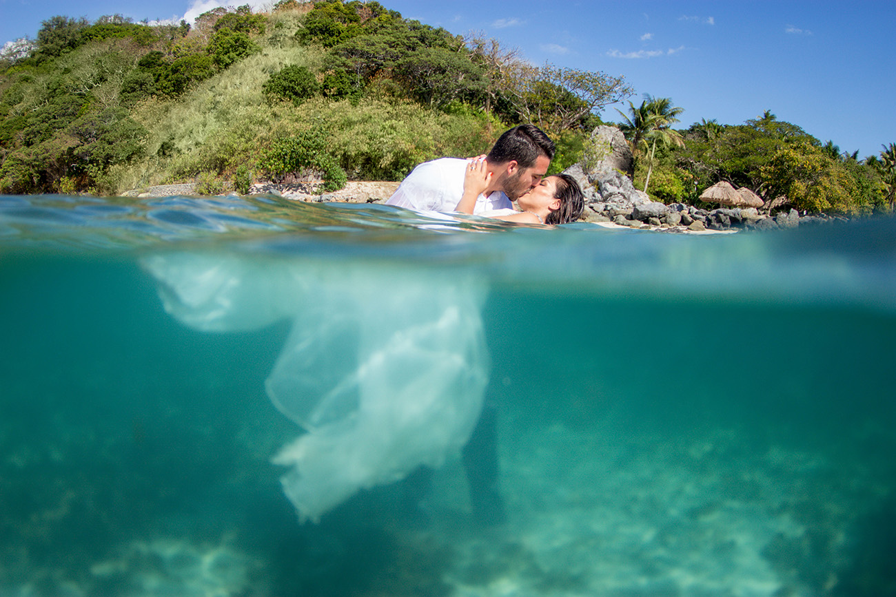 Couple over under water split shot at Castaway island in Fiji