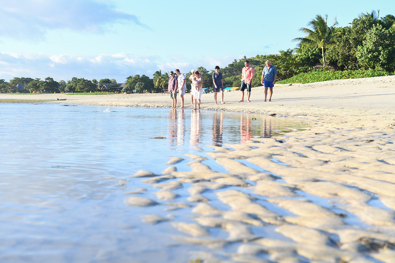 3 generations of family stand on the Natadola beach in Fiji