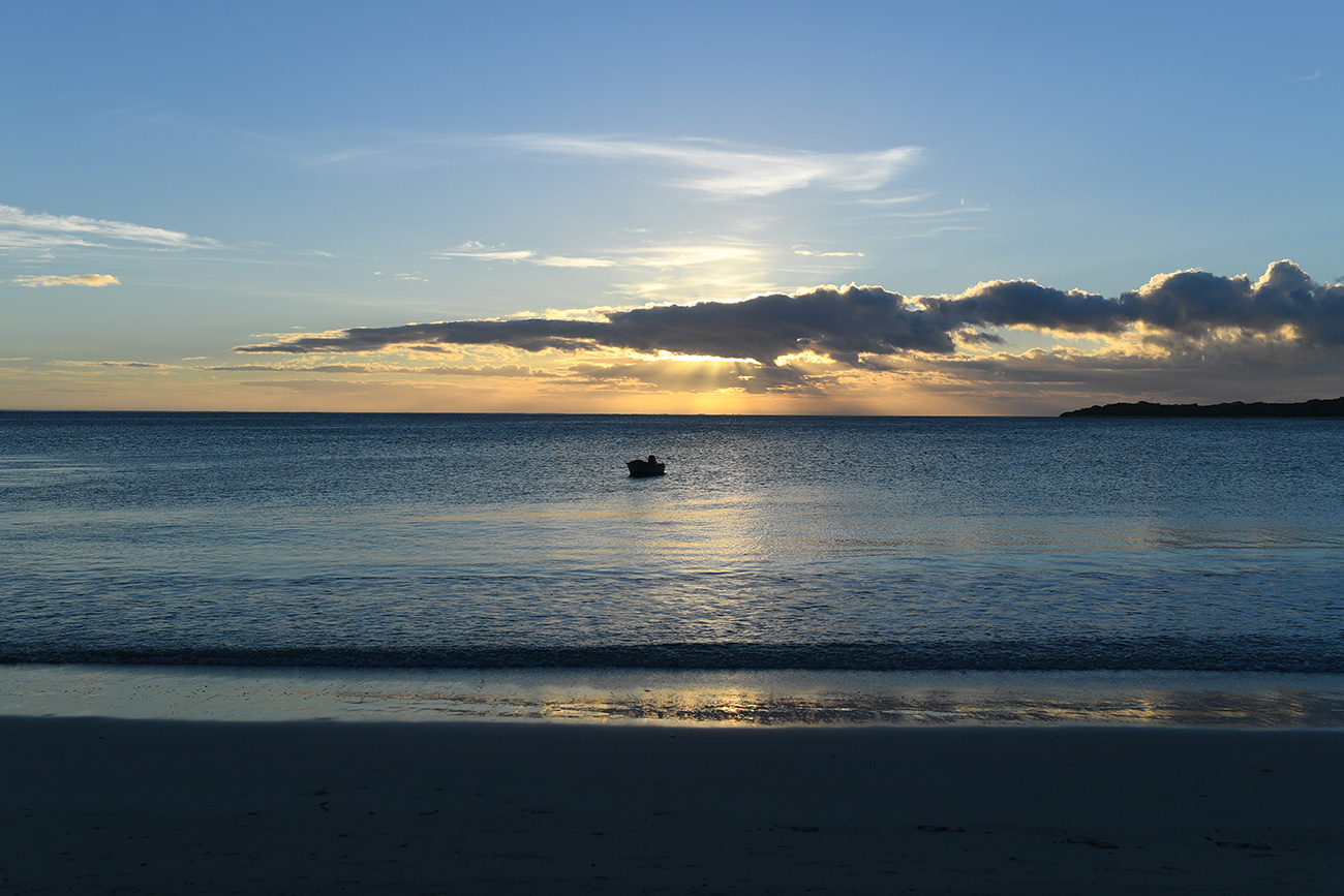 Boat floating against the stunning sunset in Natadola Fiji
