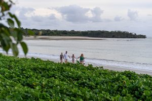 Wideshot of family walking on the beach in Fiji photoshoot