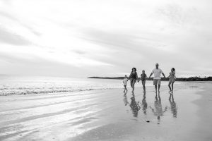 Black and white photo of family walking on the beach in Natadola Fiji