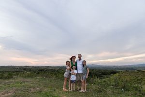 Cute family stands against sunset in the hills in Fiji