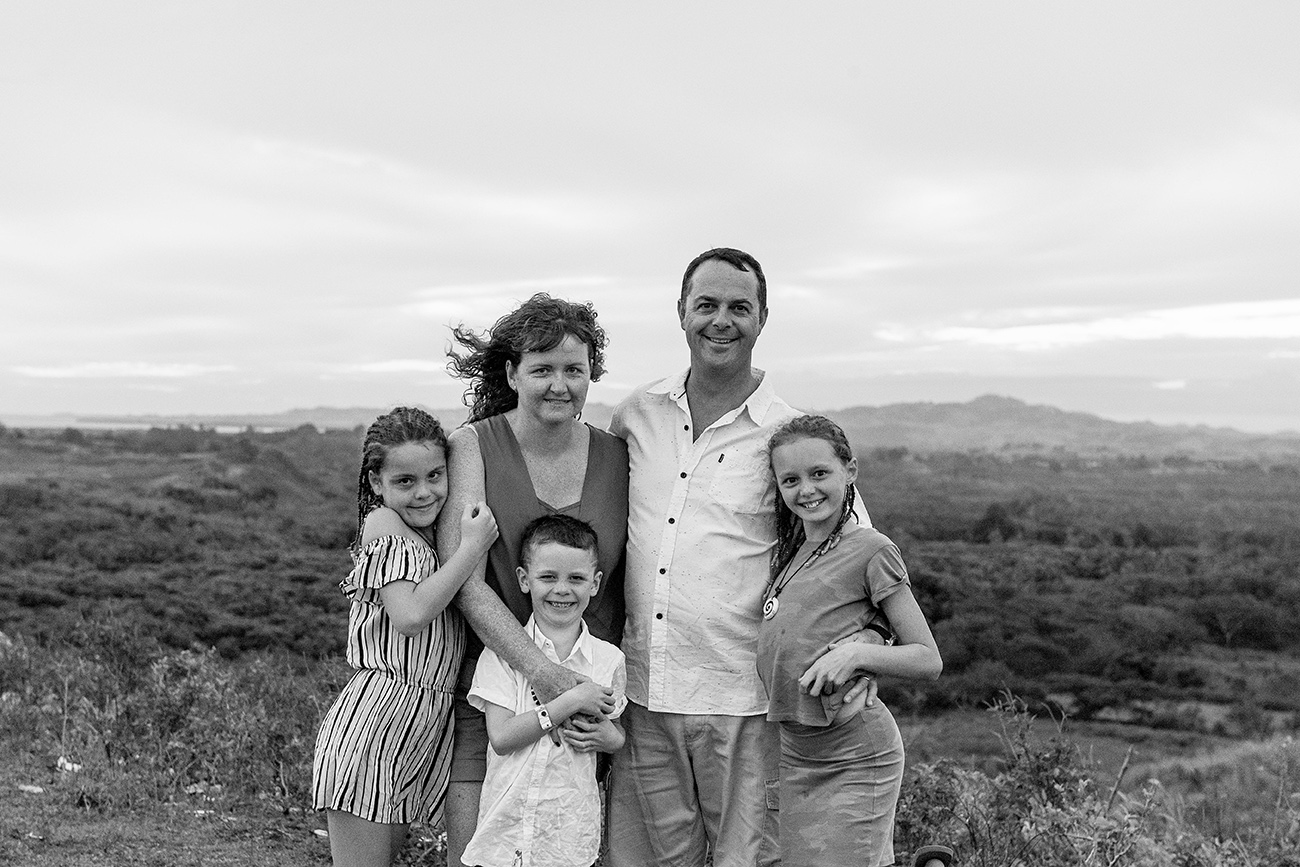 Black and white family portrait against sunset in Natadola Fiji