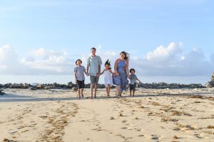 Wideshot of family on Fiji beach in family photoshoot