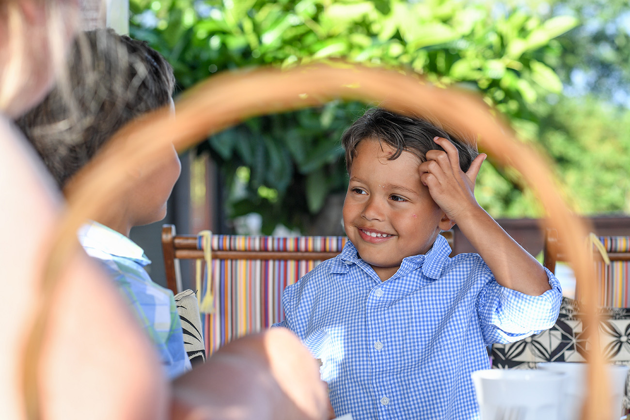 Young Polynesian boy scratching his head