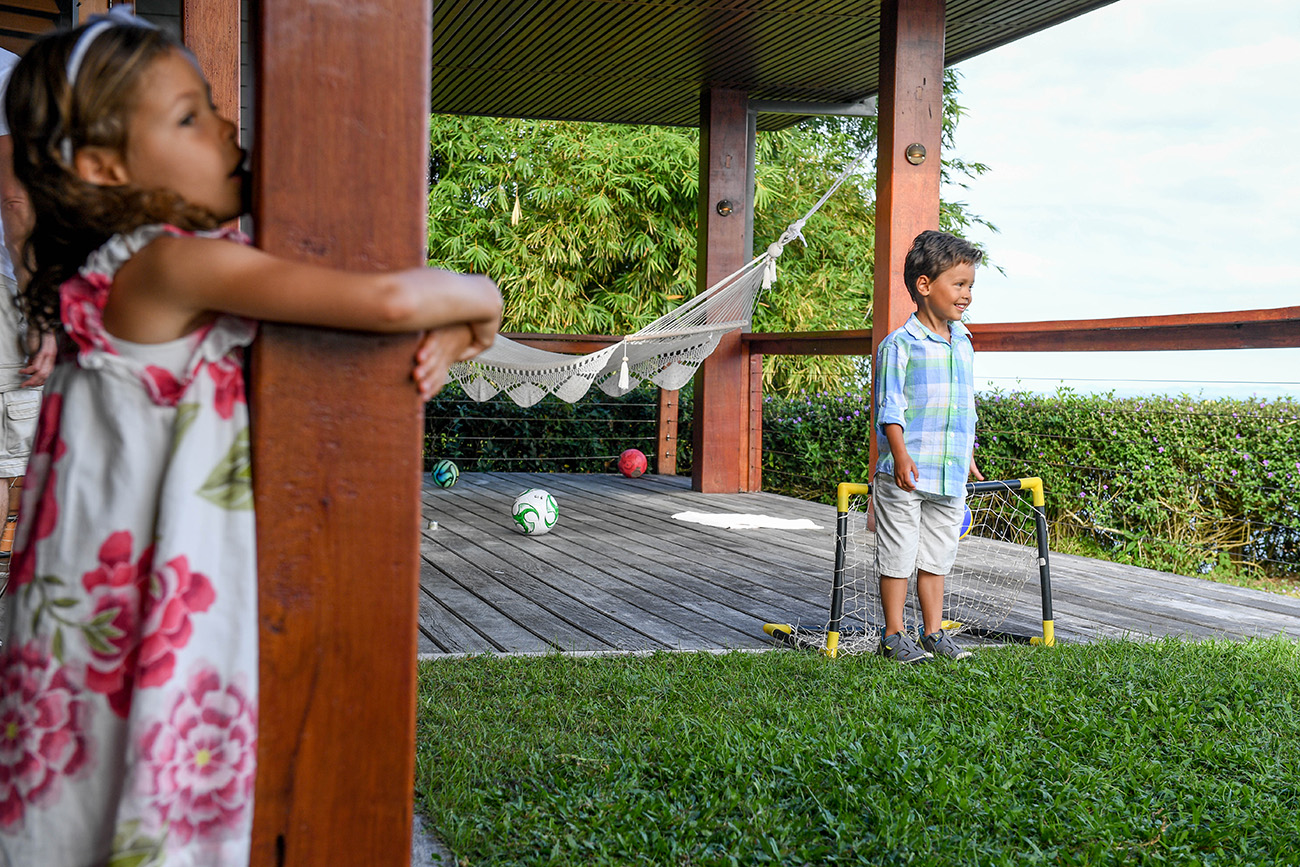 Polynesian boy plays soccer on the lawn in Fiji family vacation