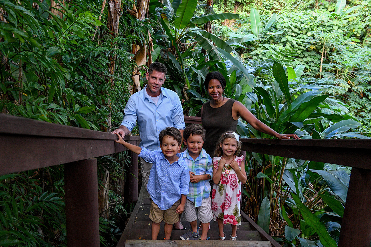 Polynesian Caucasian mixed race family pose for a picture in Fiji tropical rainforest