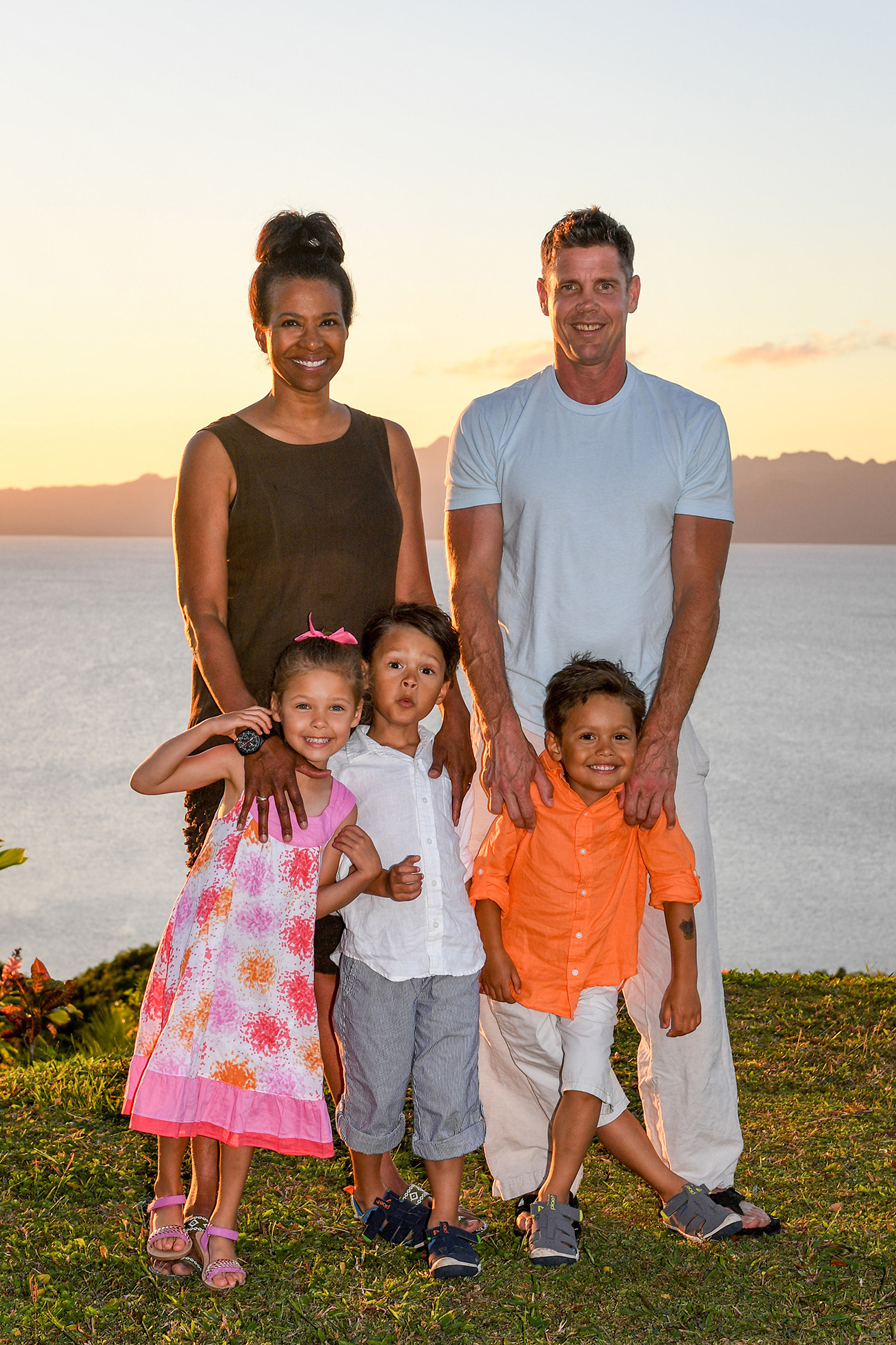 Family portrait against the ocean and sunset in Fiji family photoshoot