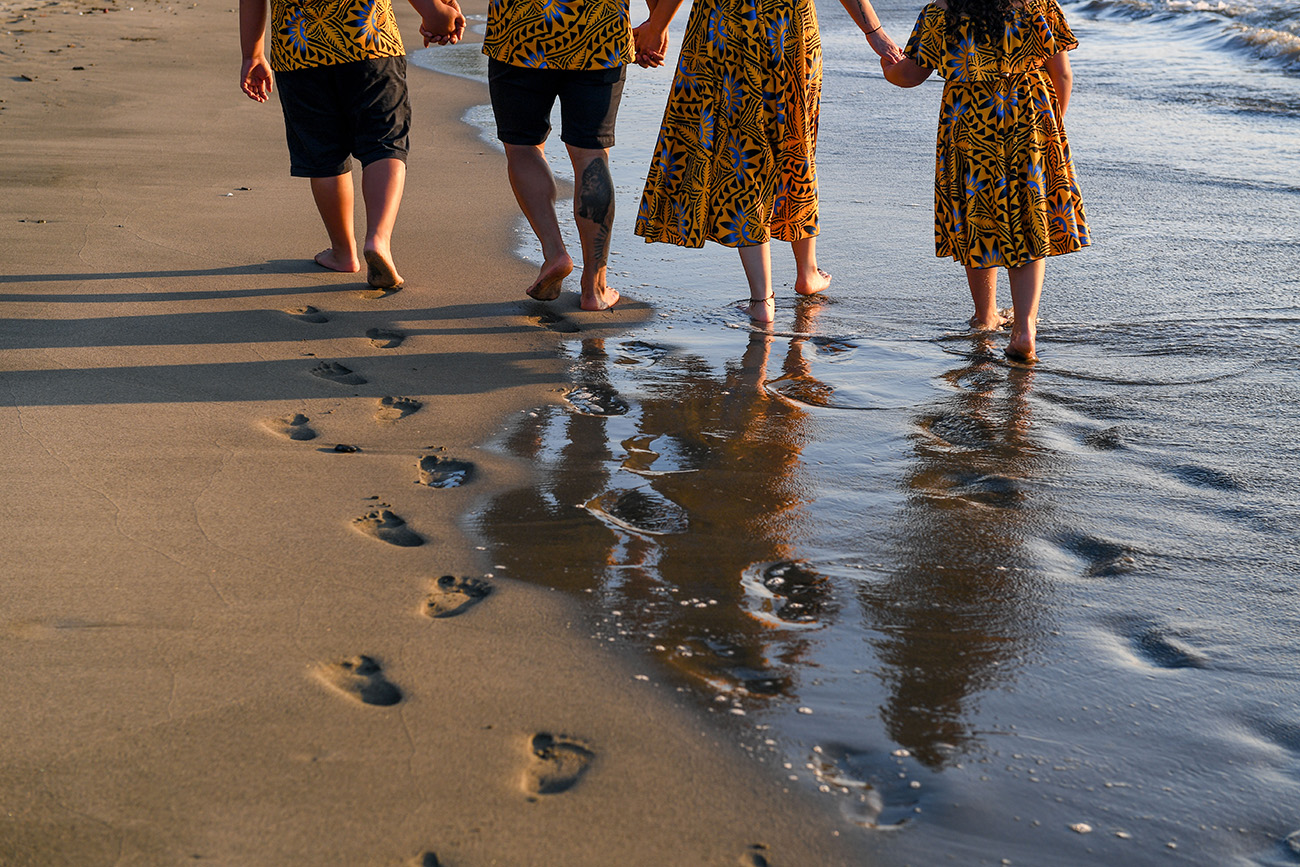 The family leaves footprints on the beach at Double Tree Hilton Fiji