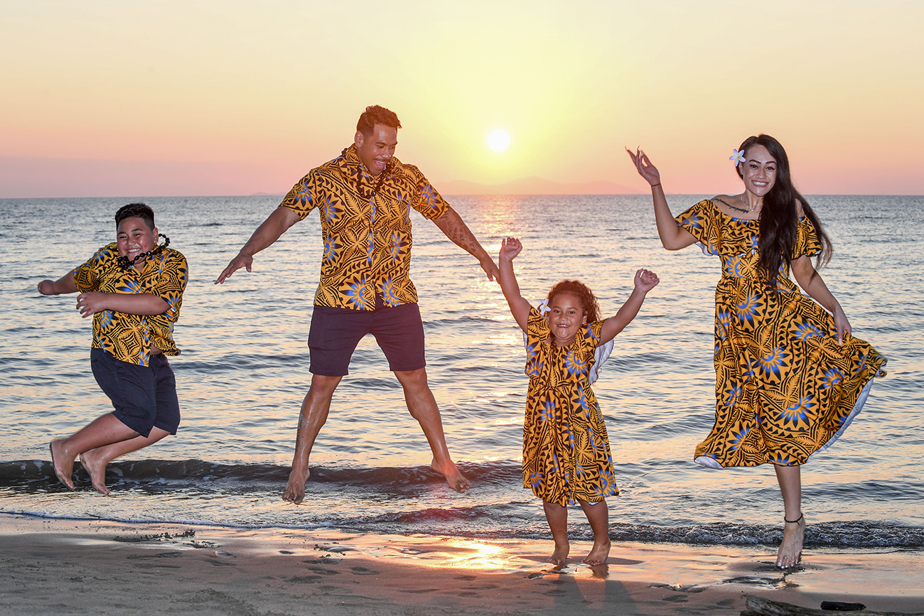 The family leaps against a golden sunset at Double Tree Hilton