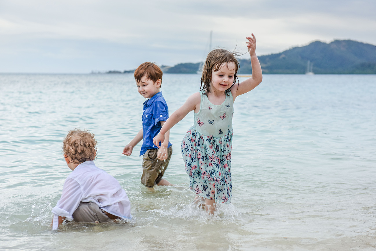 Brother's and sisters play in the sea