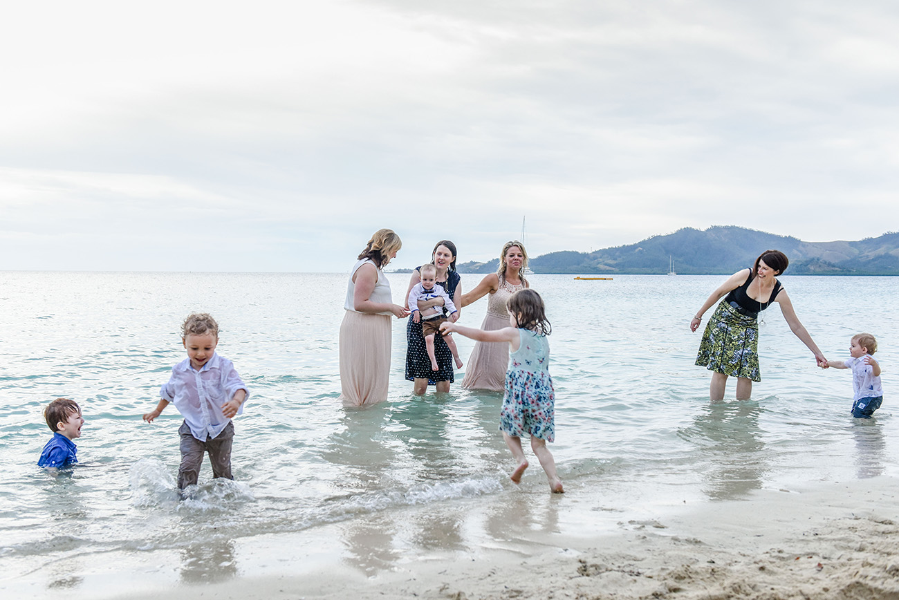 Family play in the ocean at the shores of the Fiji Plantation Island Resort