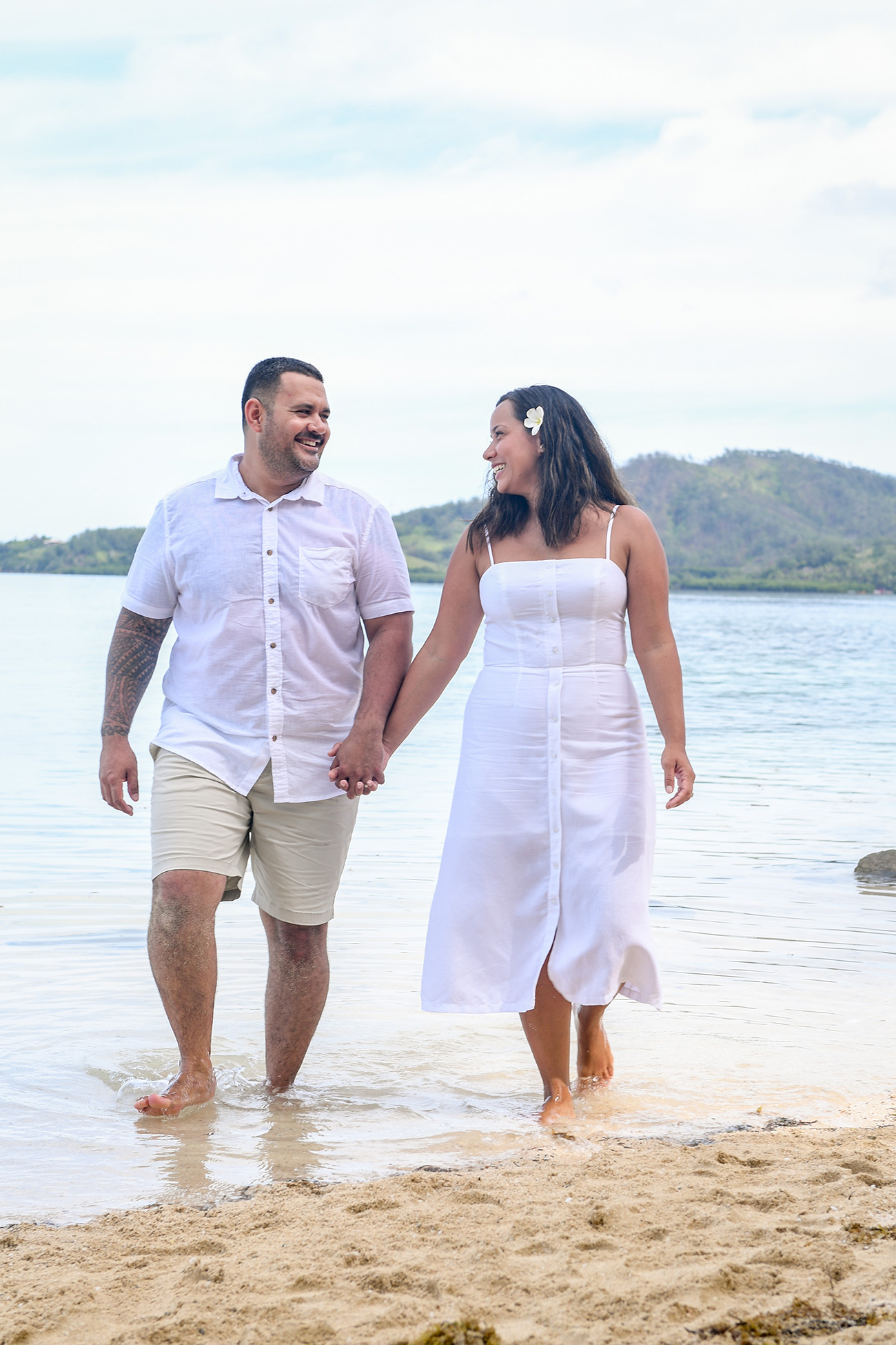 Polynesian couple strolling in the sea