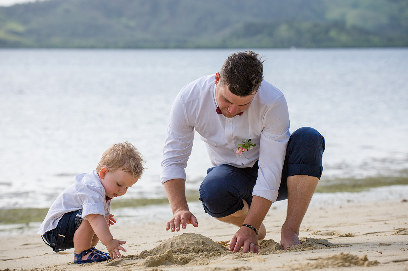father and son build sand castles at Plantation Island in Fiji