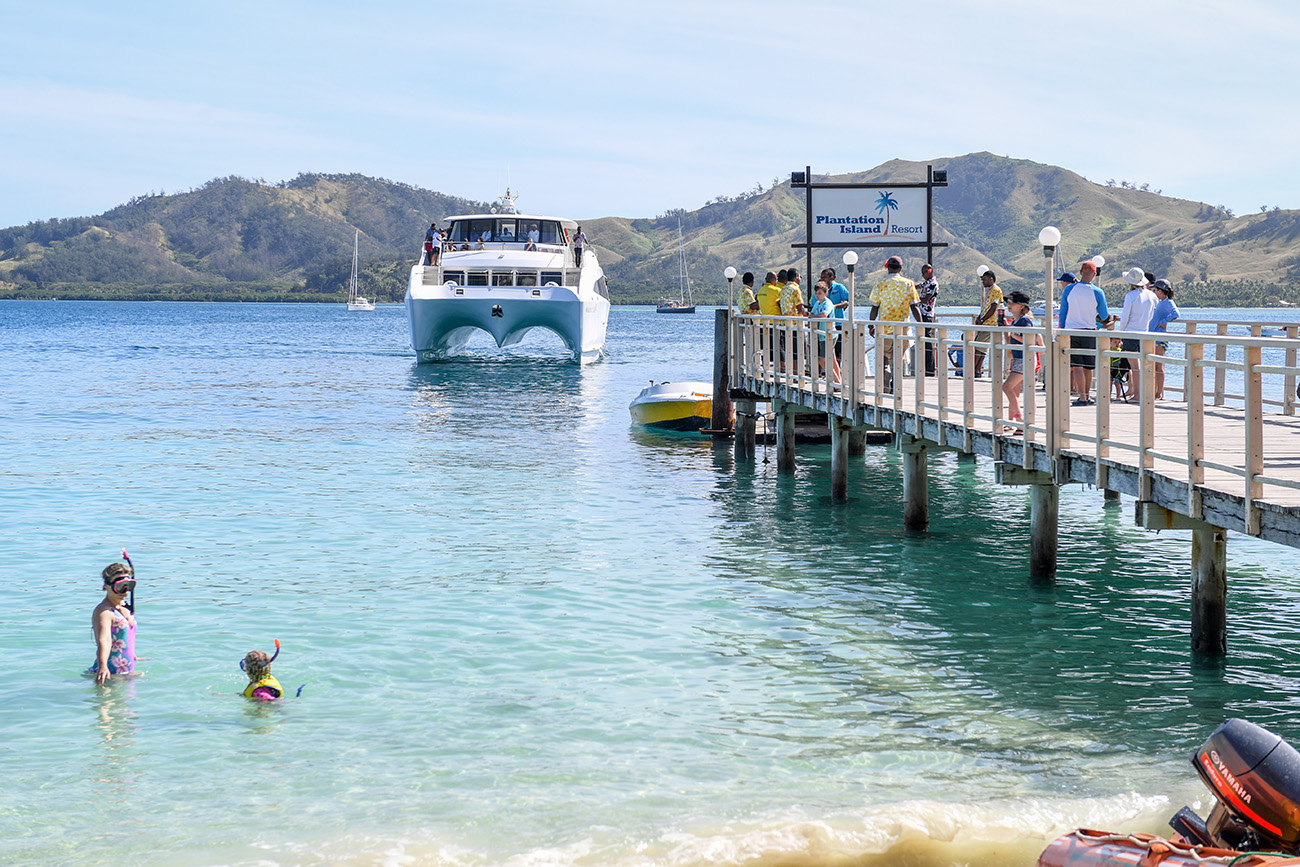 A cruise ship arrives at the dock at Plantation Island Resort Fiji
