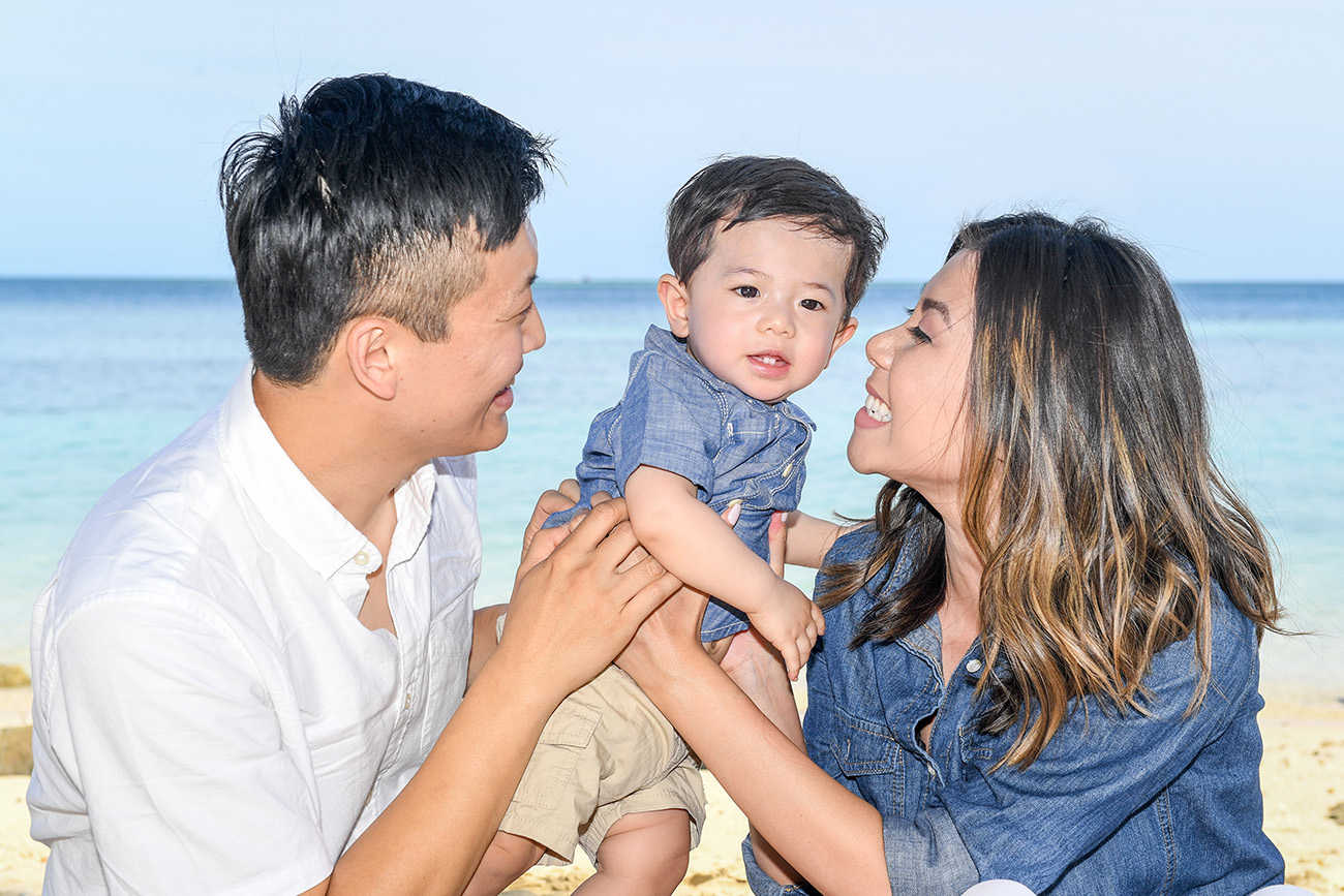 The cute little boy is given all the love by his parents at Plantation Island Resort Fiji