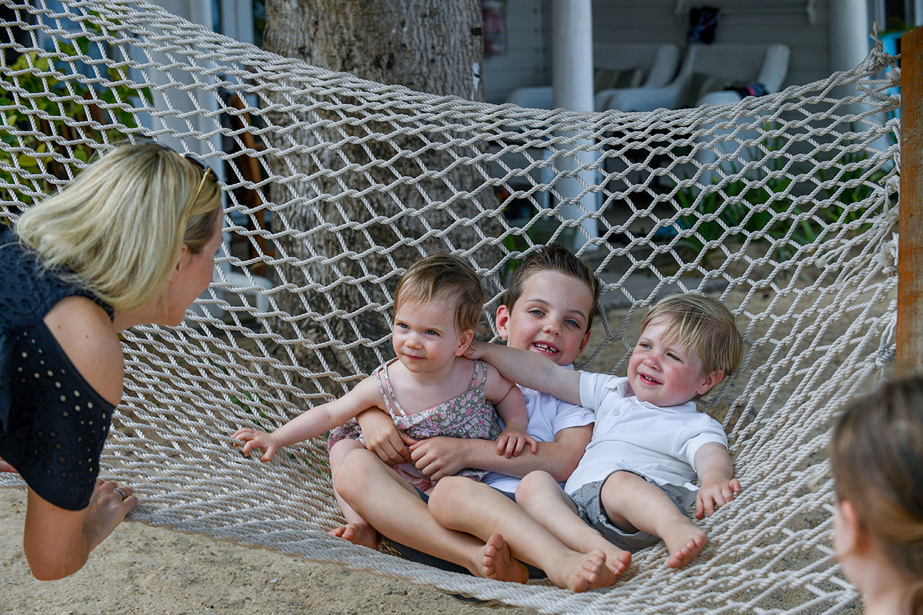 Three babies are fitted onto a hammock