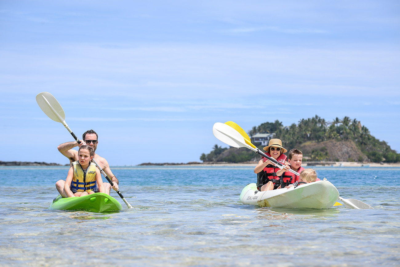 Mother and son, father and daughter canoe together at Malolo Island Resort