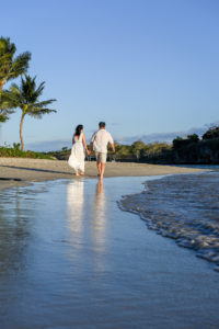 An asian couple strolls on the beach at Natadola Fiji