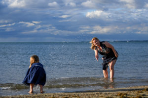 Mother plays with her daughter on the shores of Denerau Fiji