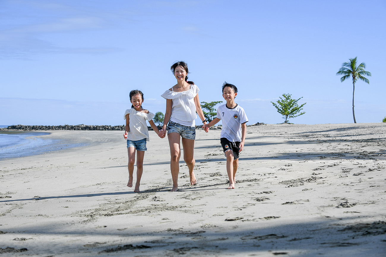 Cute asian family on the beach at Natadola Fiji