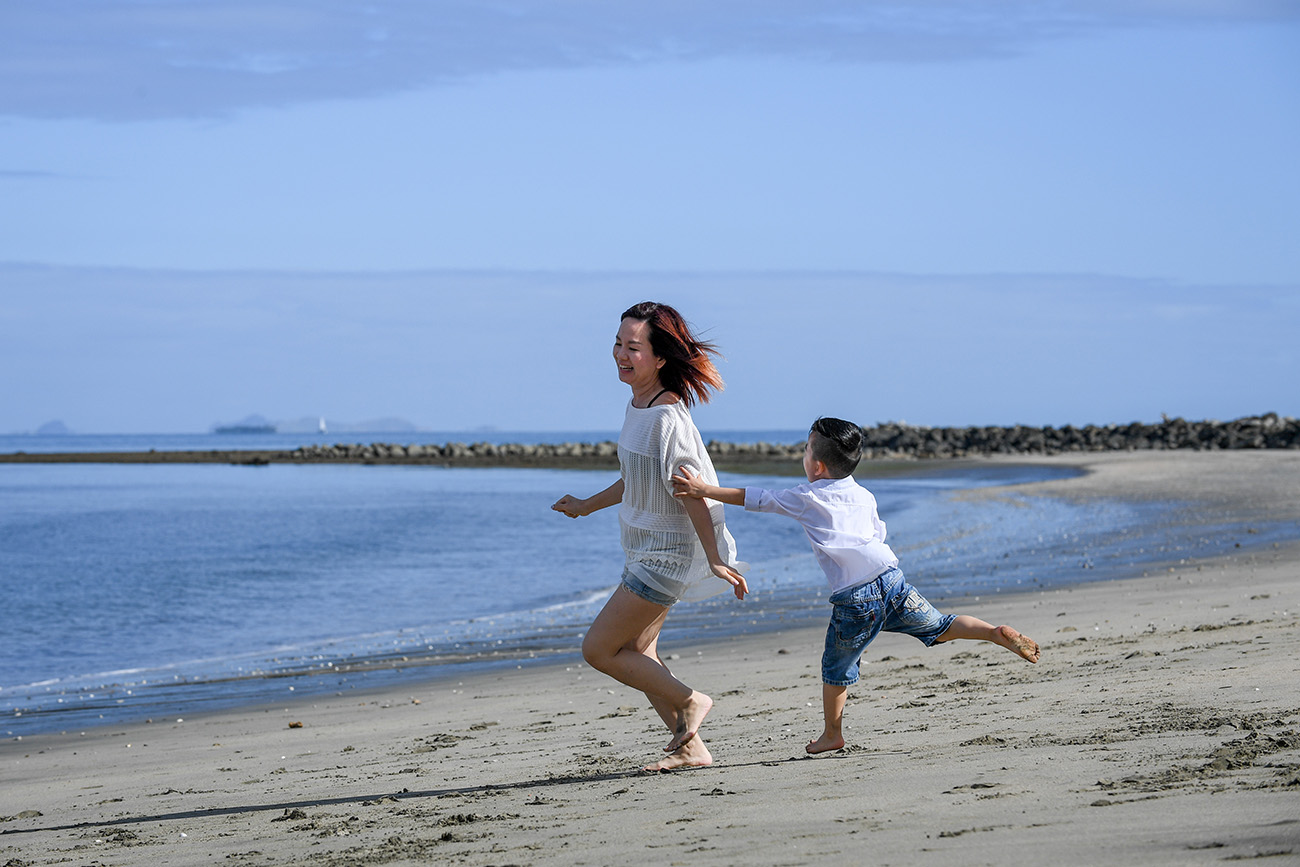 Mother and son play on the beach at Natadola Fiji