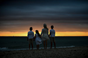 Silhouette of the family starring at the beach