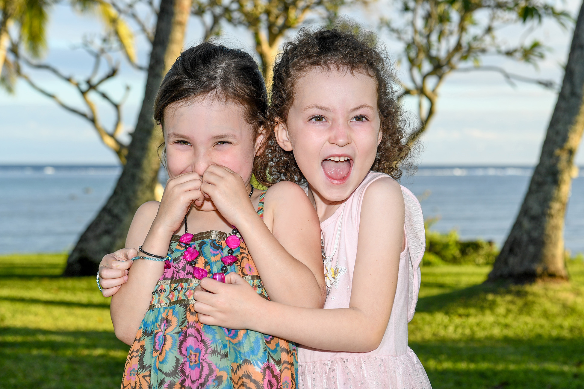 Sisters acting silly and hugging during the photo session in Fiji
