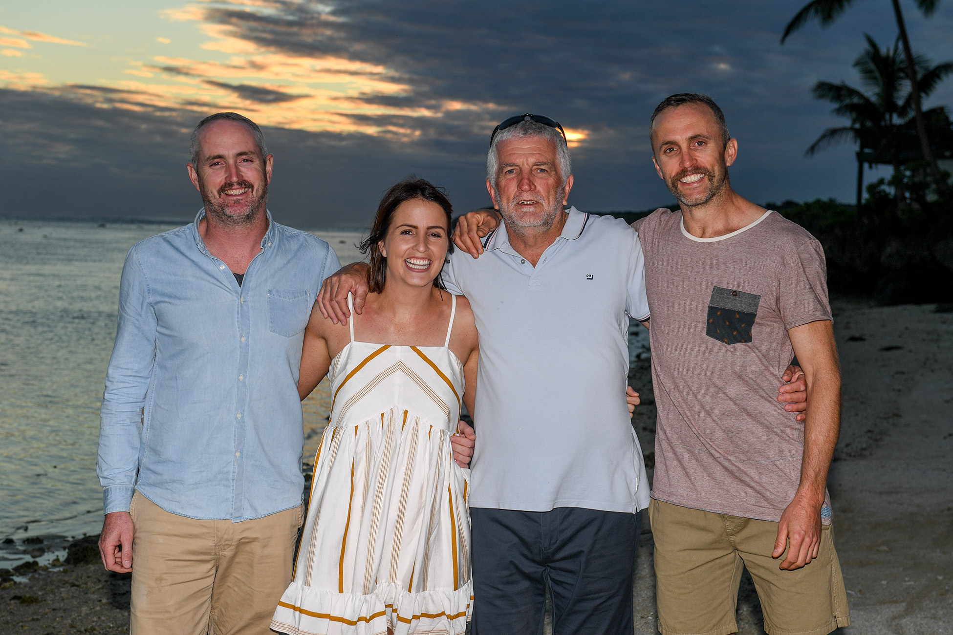 Group shot of the father with his children at sunset in Fiji